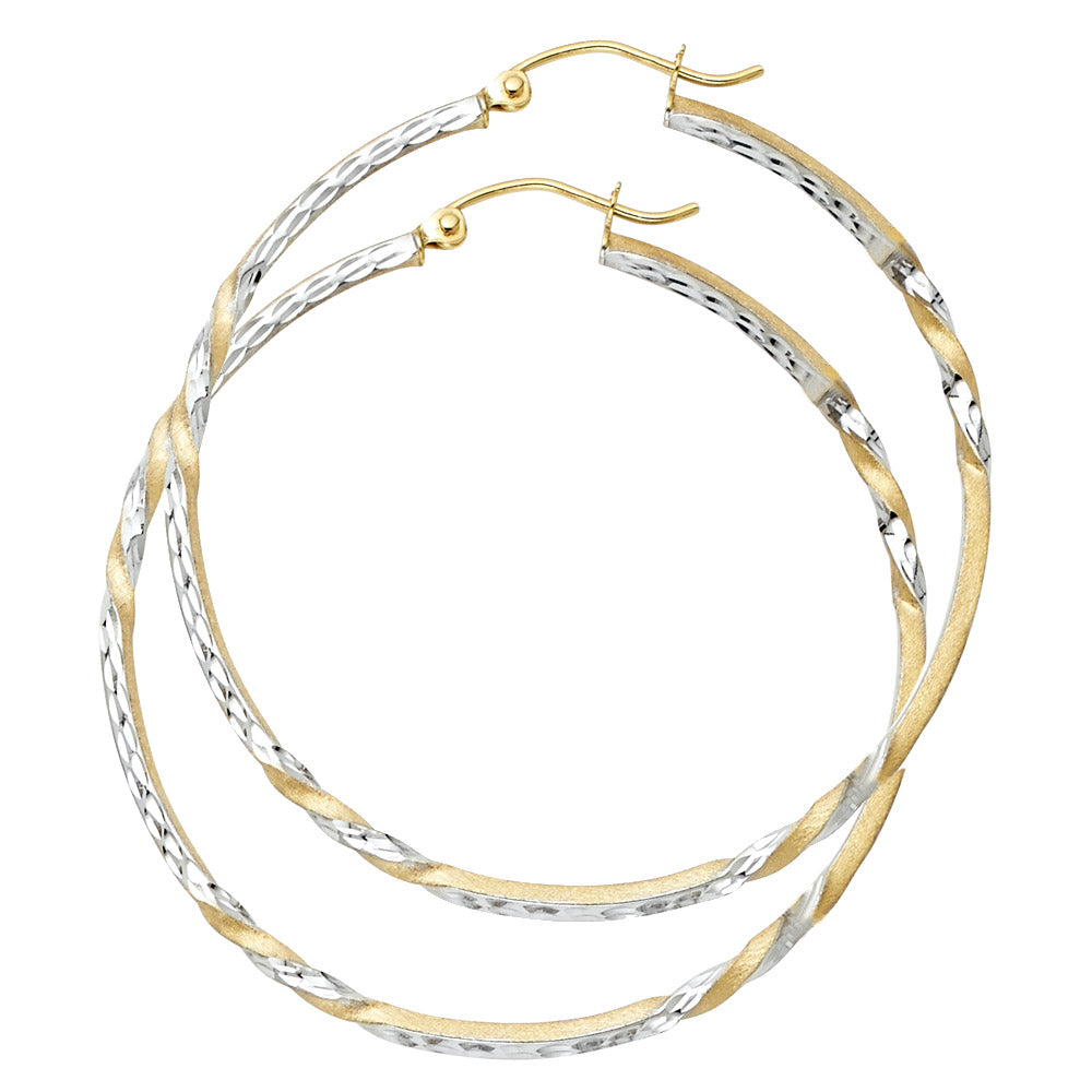 Pair of gold and silver hoop earrings on a white background
