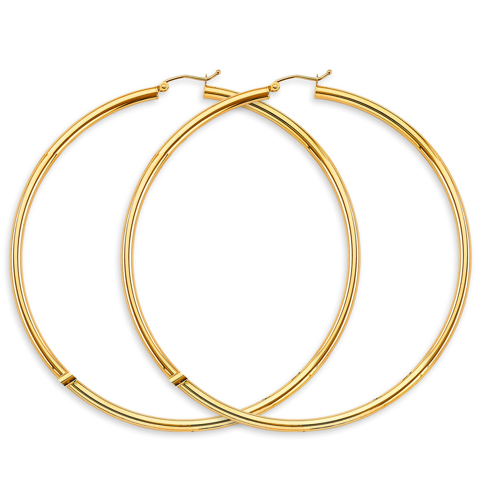 Gold hoop earrings on a white background available on the TX.ORO website.