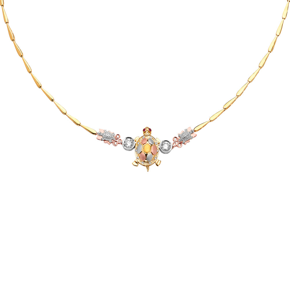 Gold turtle pendant necklace with gemstones on a white background available on the TX.ORO website.