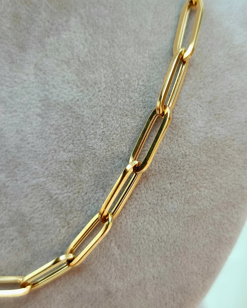 Gold chain on a light gray background available on the TX.ORO website.