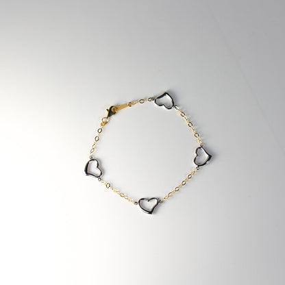 Bracelet with heart-shaped charms on a light gray background available on the TX.ORO website.