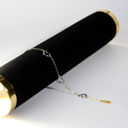 Gold bracelet on a black cylindrical stand with a white background available on the TX.ORO website.