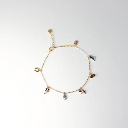 Gold bracelet with various charms on a white background available on the TX.ORO website.