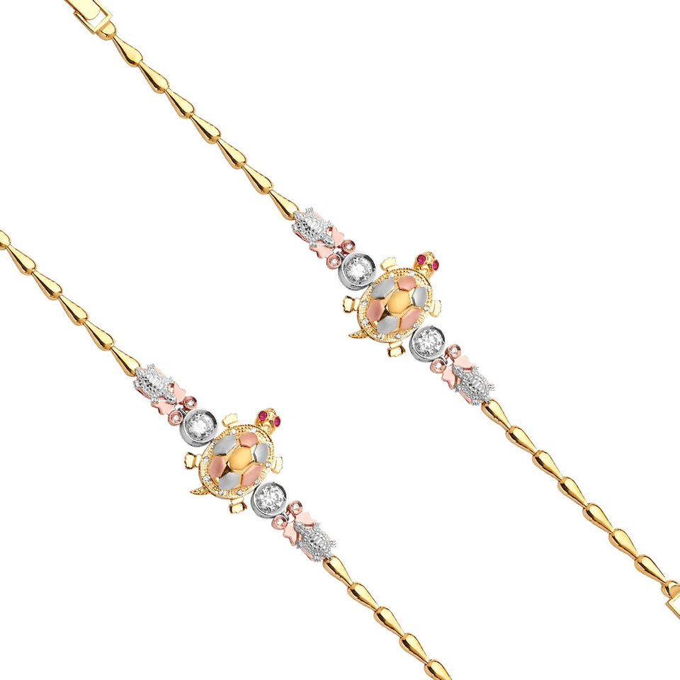 Gold necklace with turtle charms and gemstones on a white background available on the TX.ORO website.