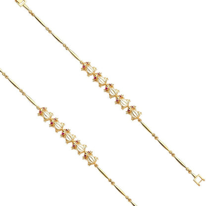 Gold bracelet with red gemstones on a white background available on the TX.ORO website.