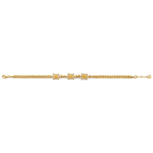 Gold bracelet with a central gemstone on a white background available on the TX.ORO website.
