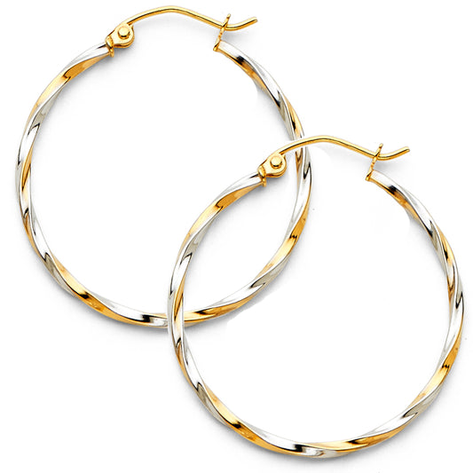 Gold and silver hoop earrings on a white background