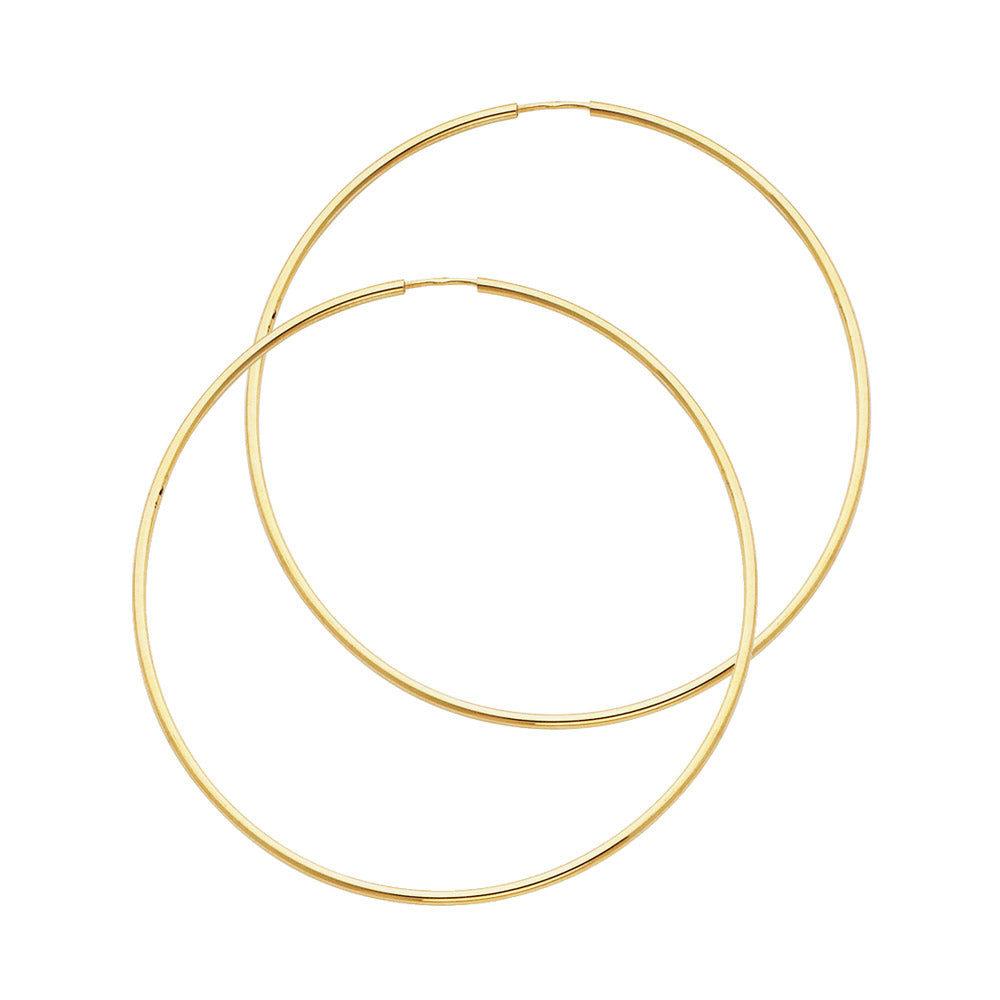Gold hoop earrings on a white background available on the TX.ORO website.