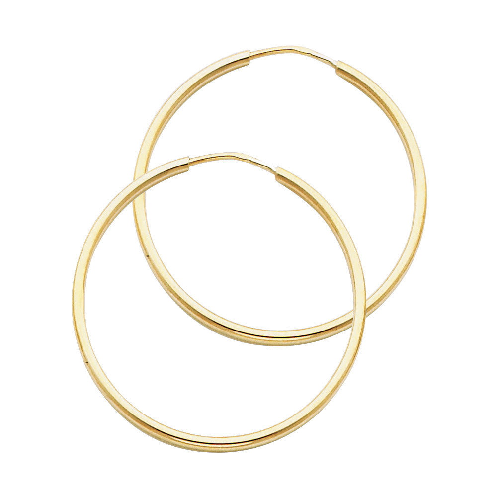 Gold hoop earrings on a white background available on the TX.ORO website.