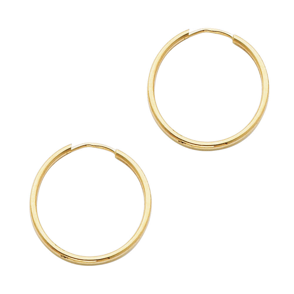 Gold hoop earrings on a white background available on the TX.ORO website.