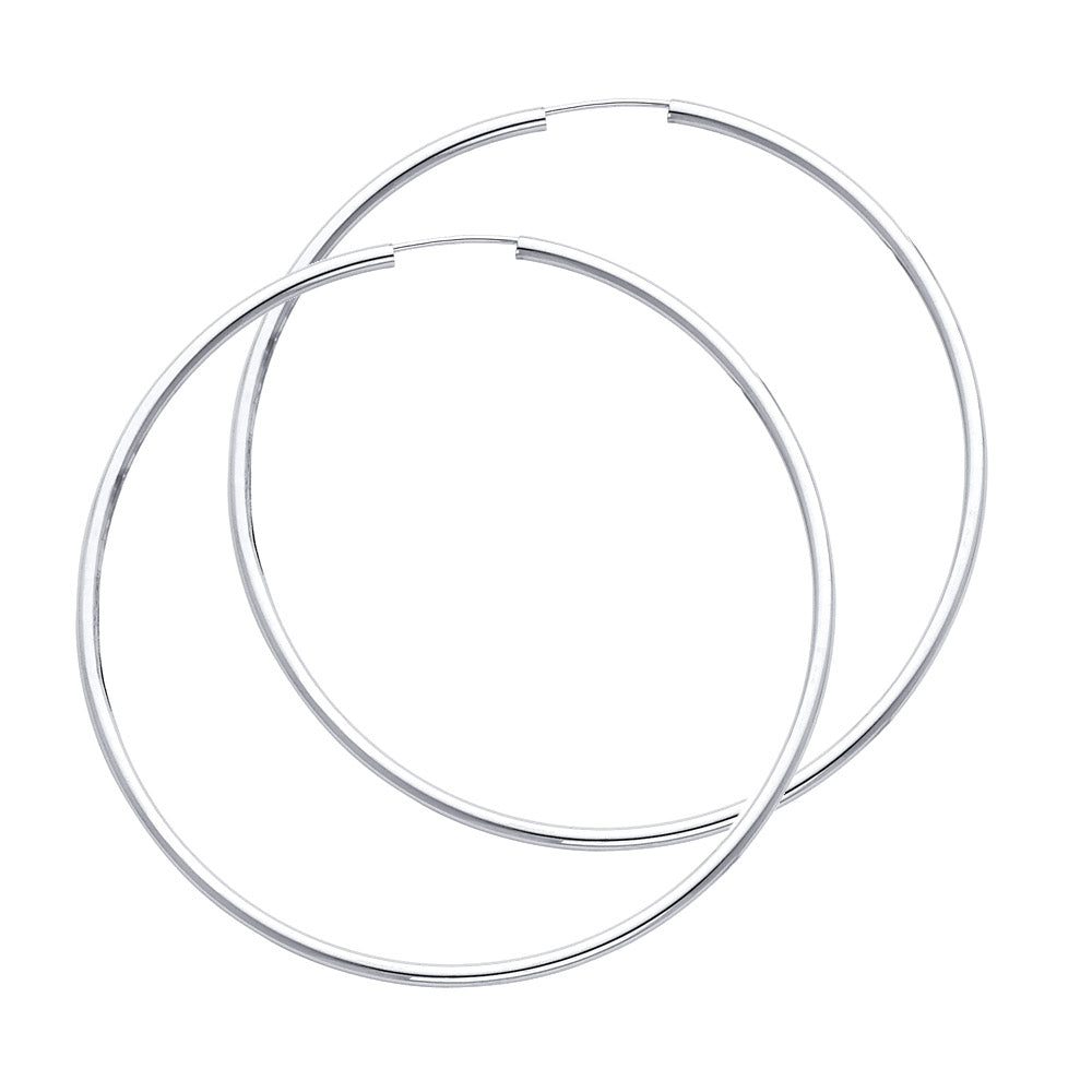 Two silver hoop earrings on a white background available on the TX.ORO website.