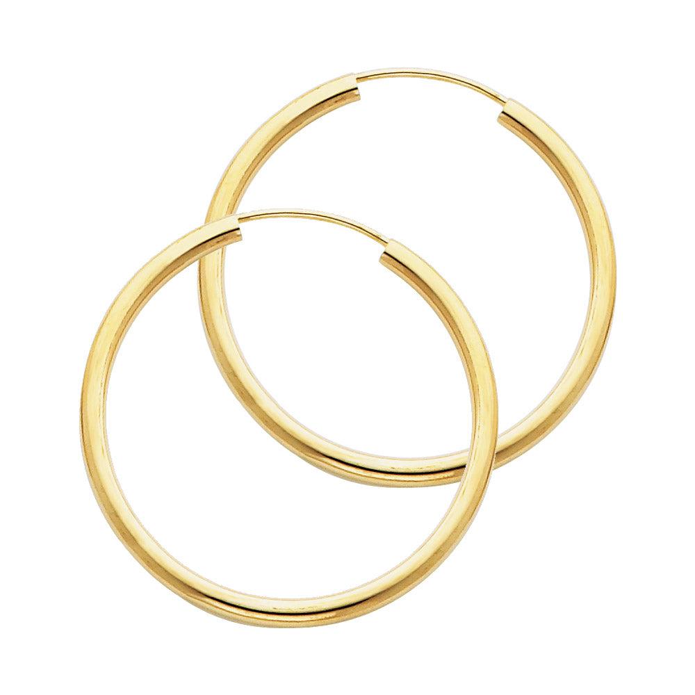 Two gold hoop earrings on a white background available on the TX.ORO website.