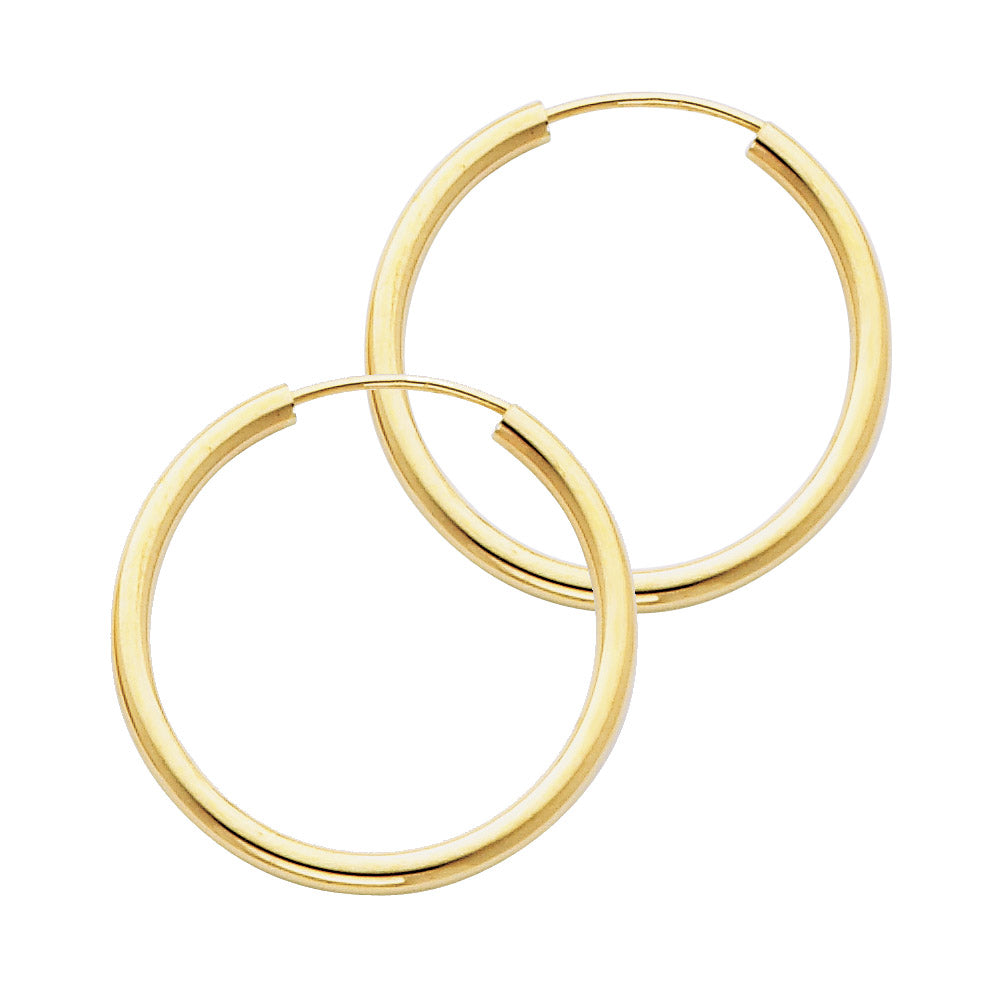 Two gold hoop earrings on a white background available on the TX.ORO website.