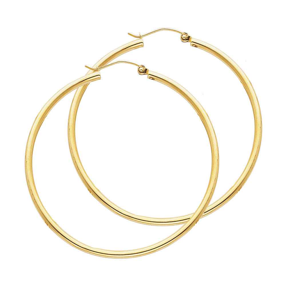 Gold hoop earrings on a white background available on the TX.ORO website.