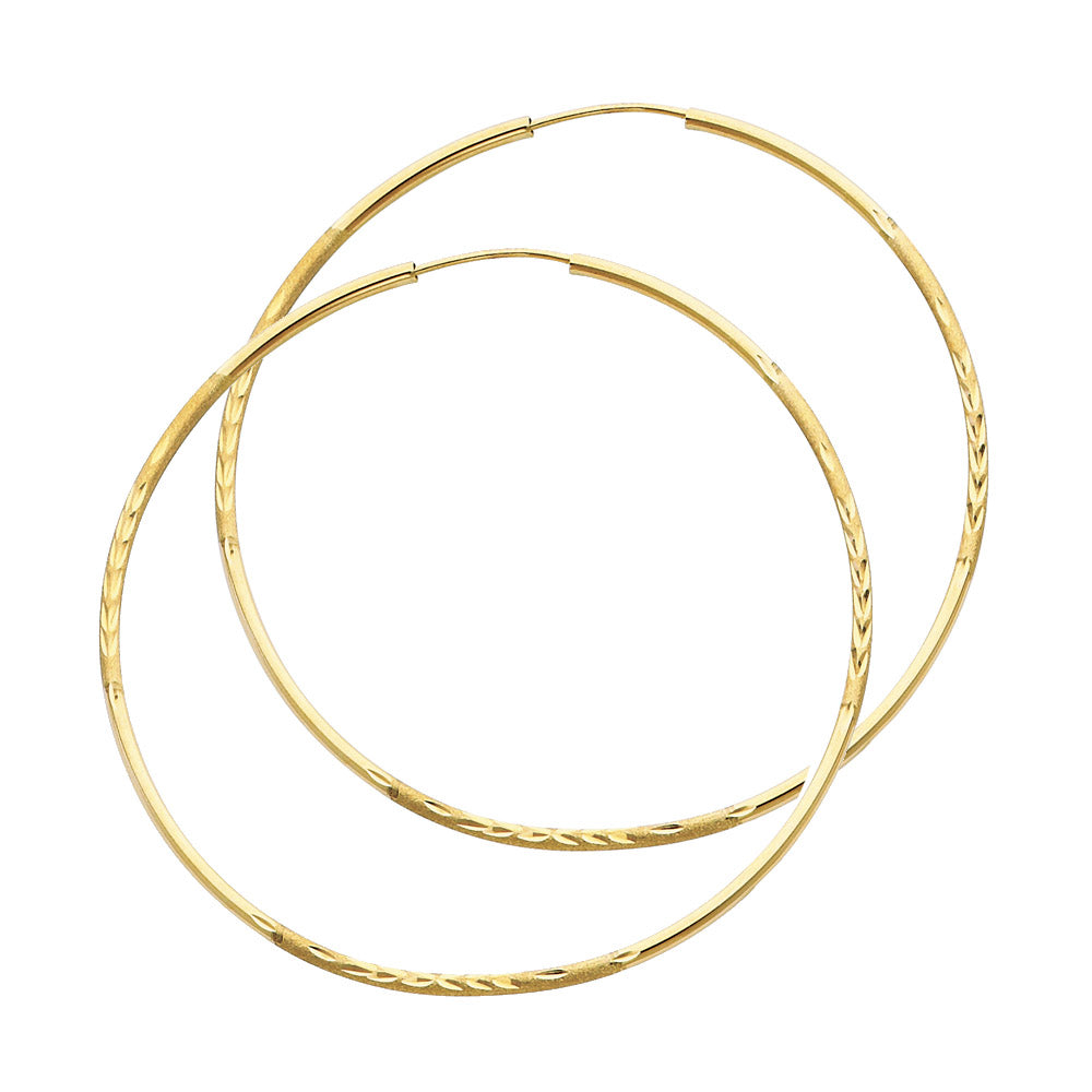 Pair of gold hoop earrings on a white background available on the TX.ORO website.
