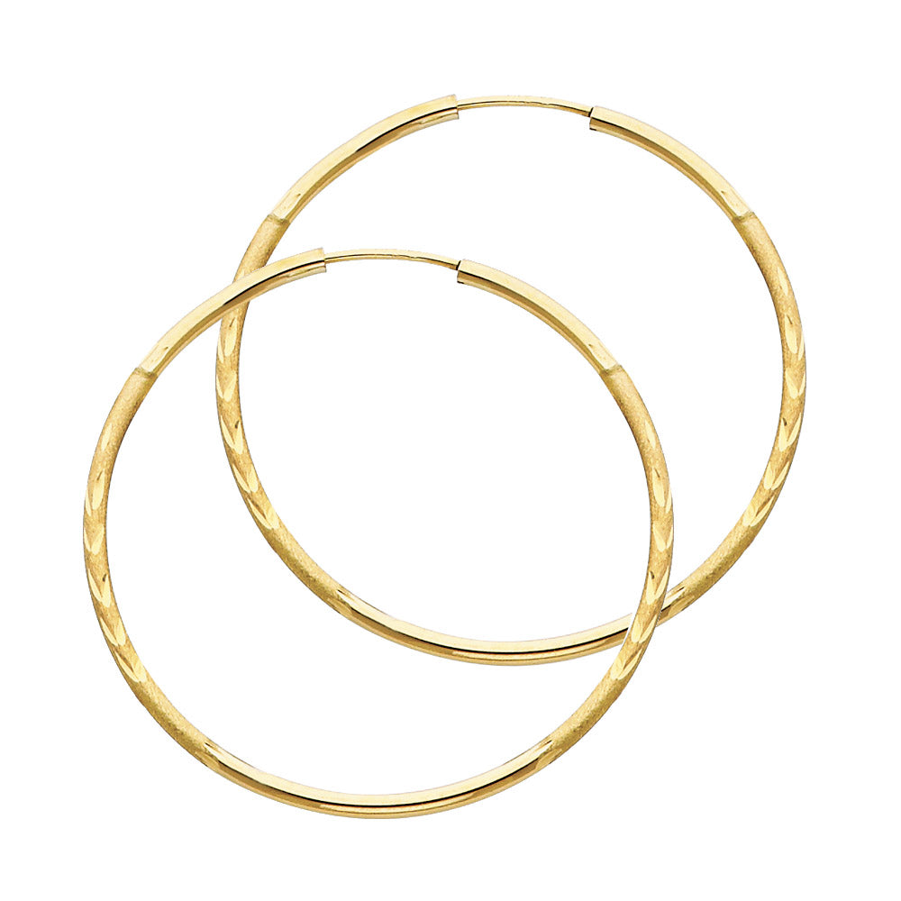 Pair of gold hoop earrings on a white background available on the TX.ORO website.