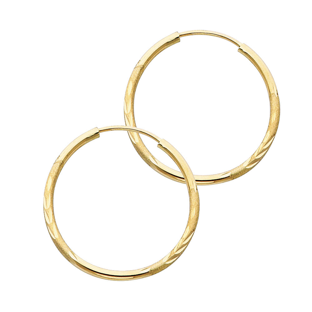 Pair of gold hoop earrings on a white background available on the TX.ORO website.