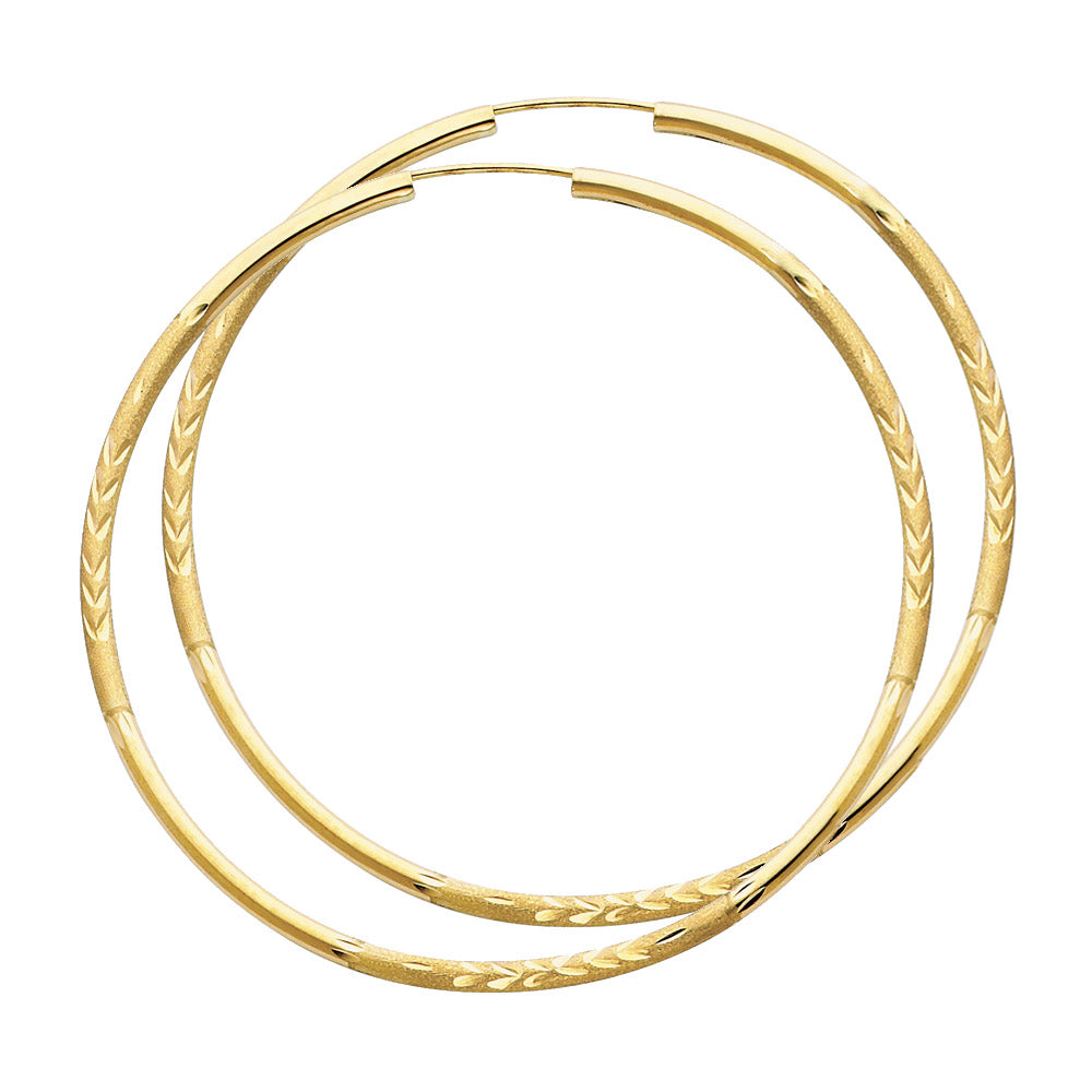 A pair of Gold hoop earrings on a white background available on the TX.ORO website.