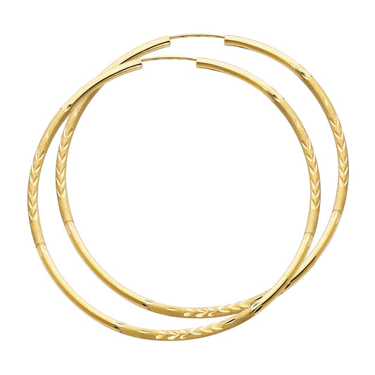 A pair of Gold hoop earrings on a white background available on the TX.ORO website.
