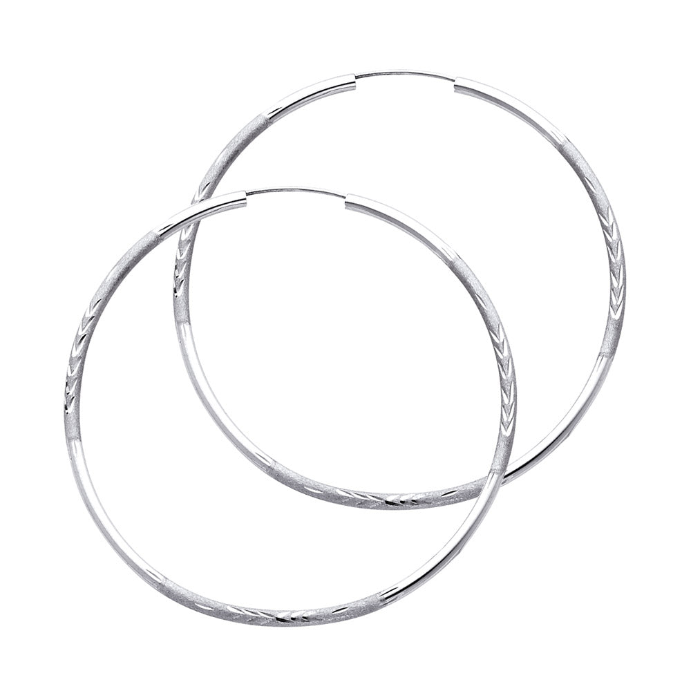 A Pair of White Gold hoop earrings on a white background available on the TX.ORO website.