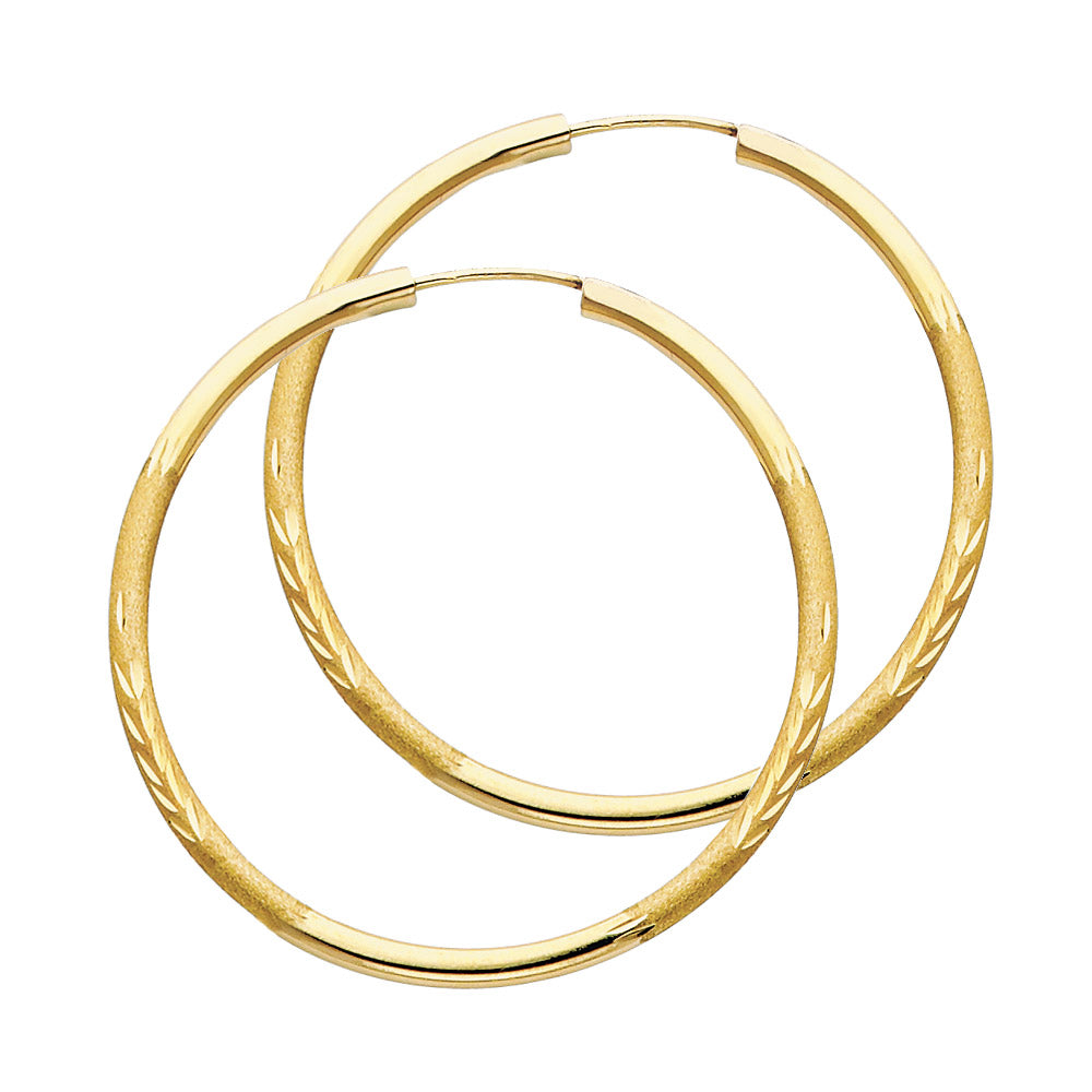 A pair of Gold hoop earrings on a white background available on the TX.ORO website.