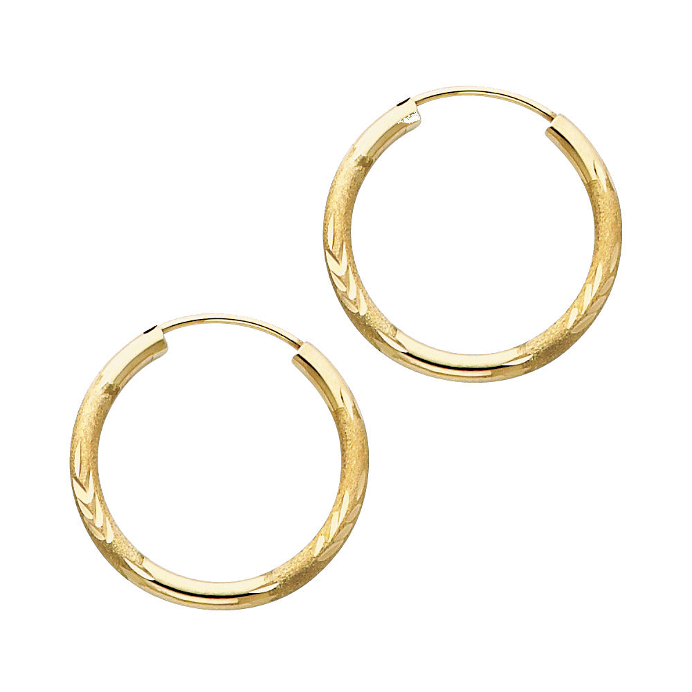 A pair of Gold hoop earrings on a white background available on the TX.ORO website.
