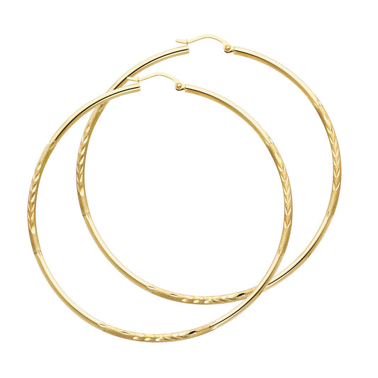 Gold hoop earrings on a white background available on the TX.ORO website.