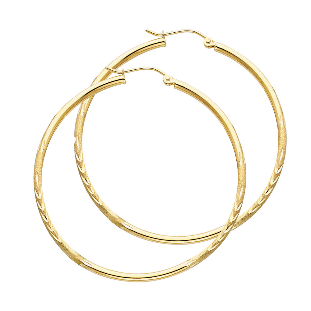 Gold hoop earrings on a white background available on the TX.ORO website.