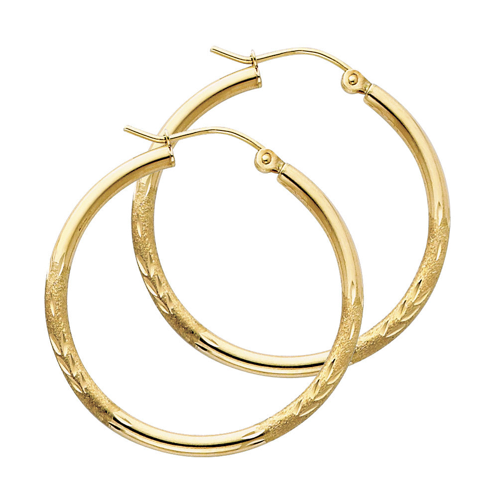 Gold hoop earrings on a white background available on the TX.ORO website.