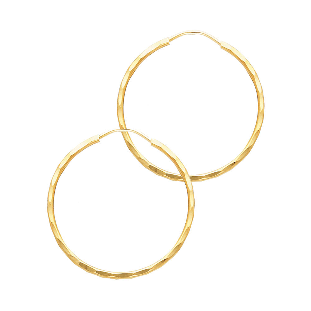 Gold hoop earrings on a white background available on the TX.ORO website.