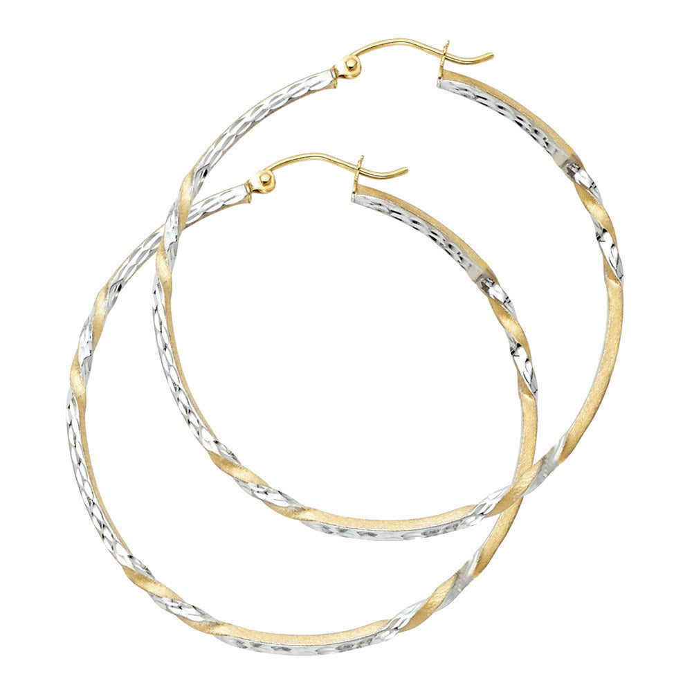 Pair of gold and silver hoop earrings on a white background