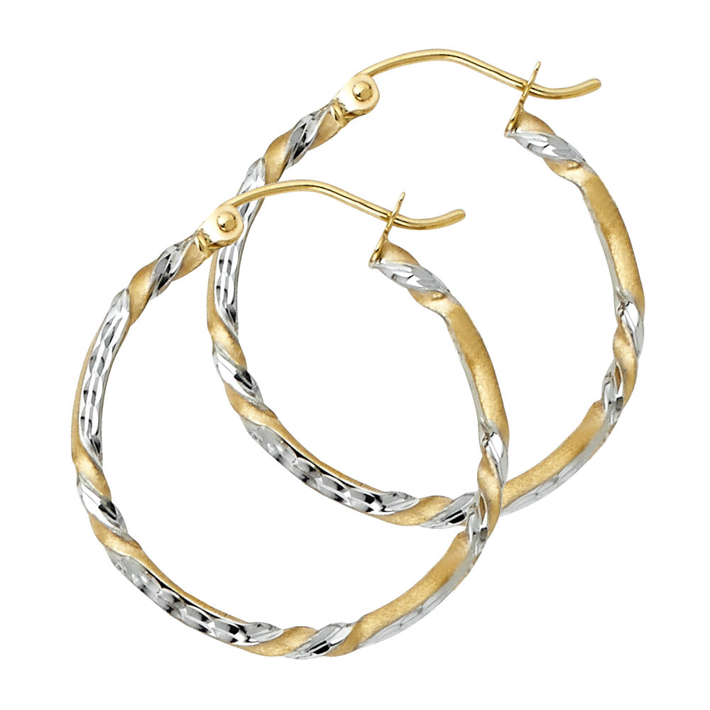 Pair of gold and silver hoop earrings on a white background