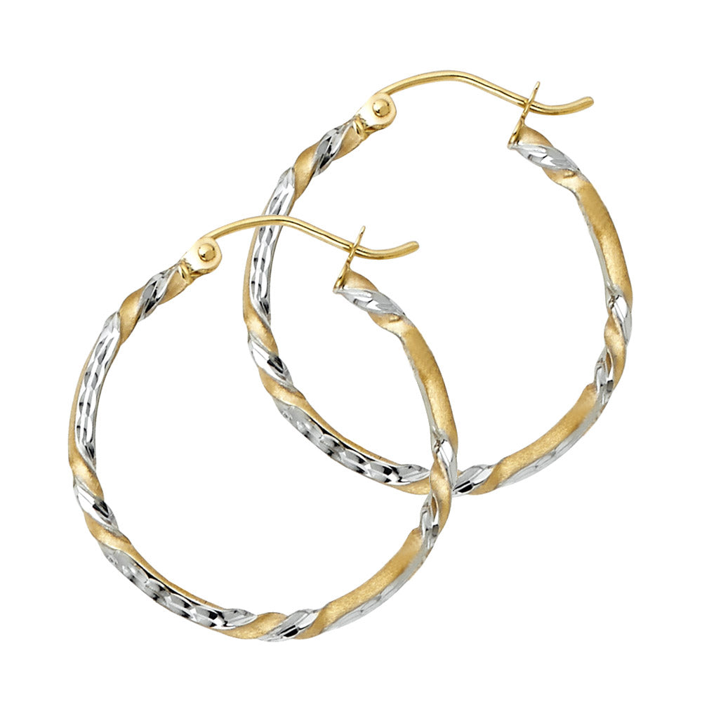 Pair of gold and silver hoop earrings on a white background