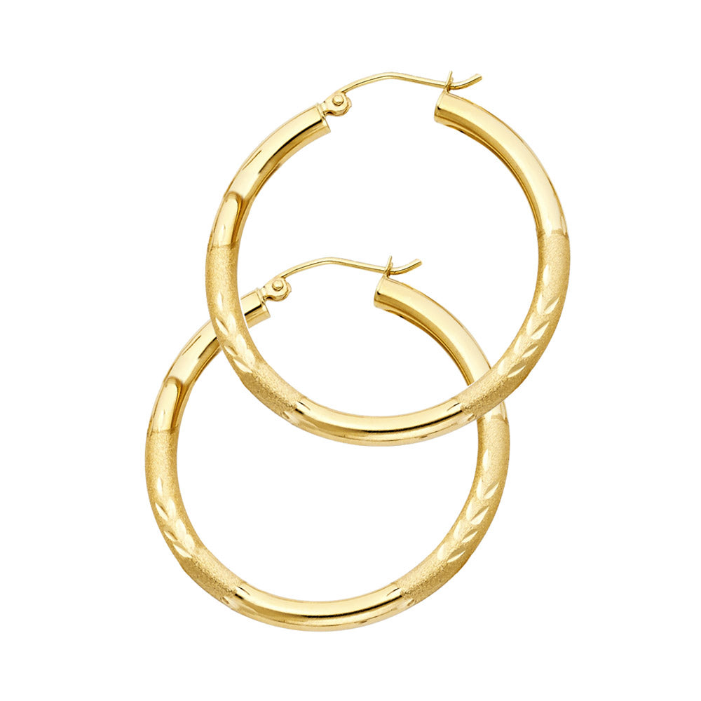 Gold hoop earrings on a white background available on the TX.ORO website.