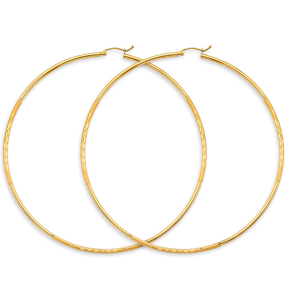Gold hoop earrings on a white background available on the TX.ORO website.