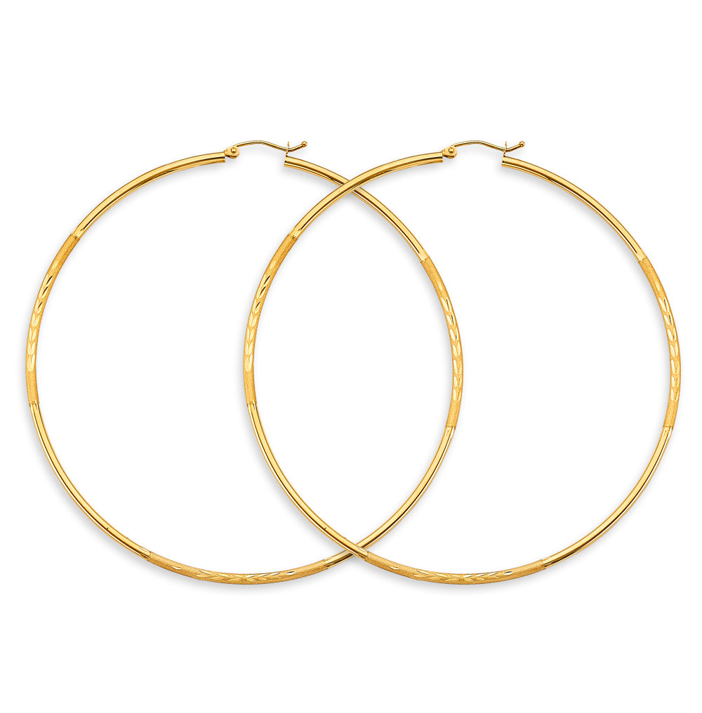 Gold hoop earrings on a white background available on the TX.ORO website.