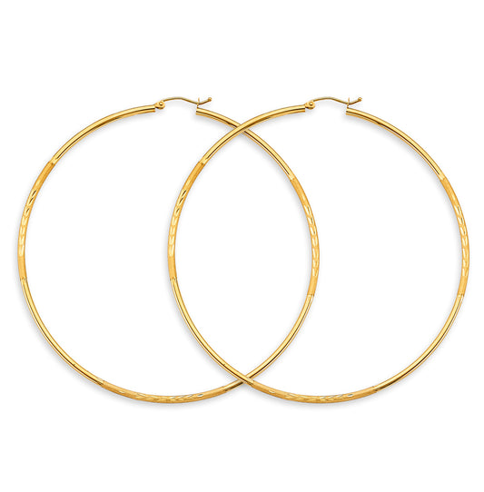 Gold hoop earrings on a white background available on the TX.ORO website.