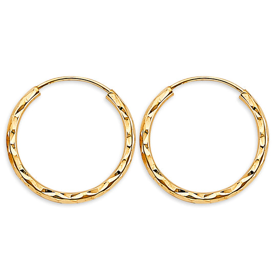 Gold hoop earrings on a white background available on the TX.ORO website.