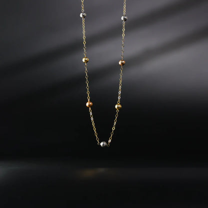 Necklace with small beads on a dark background available on the TX.ORO website.