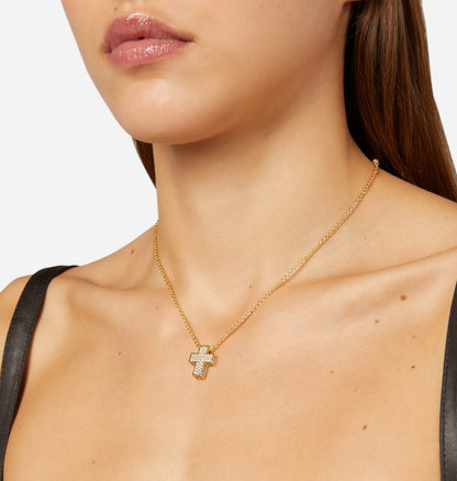 Gold necklace with a diamond cross pendant on a model against a neutral background available on the TX.ORO website.