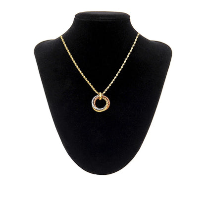 Gold necklace with a circular pendant on a black bust available on the TX.ORO website.