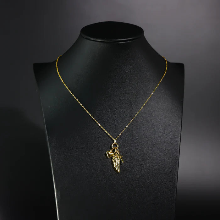 Gold necklace with a pendant on a black mannequin bust against a dark background available on the TX.ORO website.