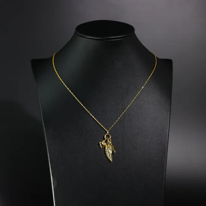 Gold necklace with a pendant on a black mannequin bust against a dark background available on the TX.ORO website.