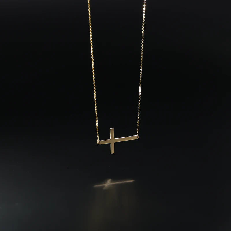 Gold necklace with a cross pendant on a black background available on the TX.ORO website.