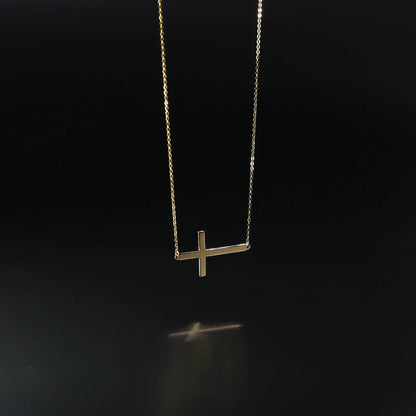 Gold necklace with a cross pendant on a black background available on the TX.ORO website.