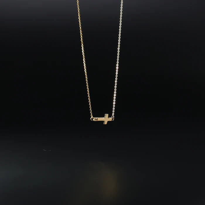 Gold necklace with a small cross pendant on a black background available on the TX.ORO website.