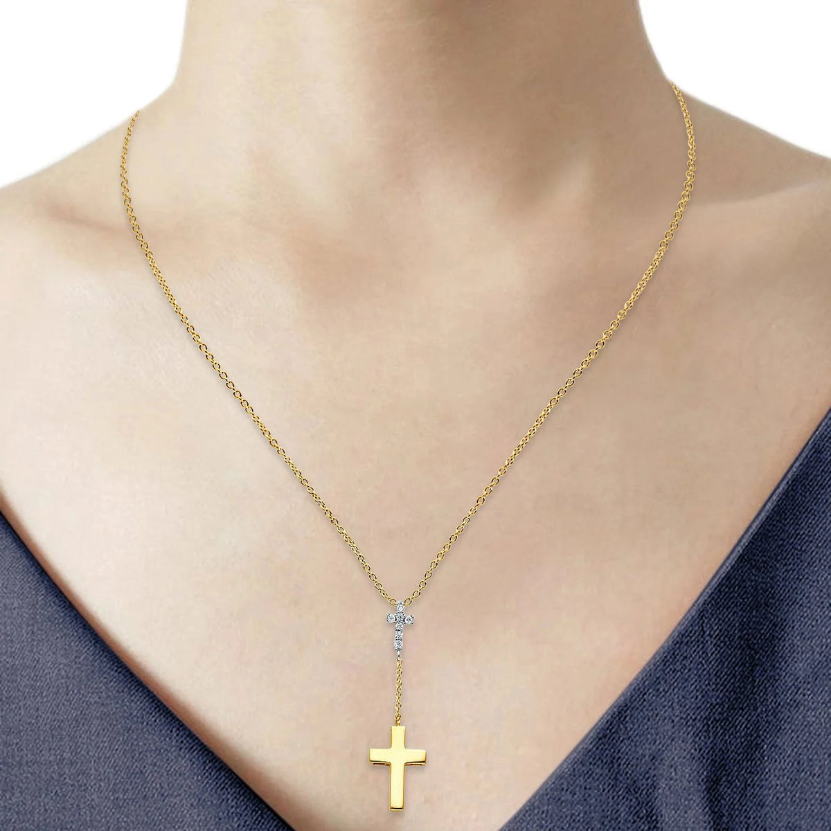 Gold necklace with a cross pendant on a mannequin available on the TX.ORO website.