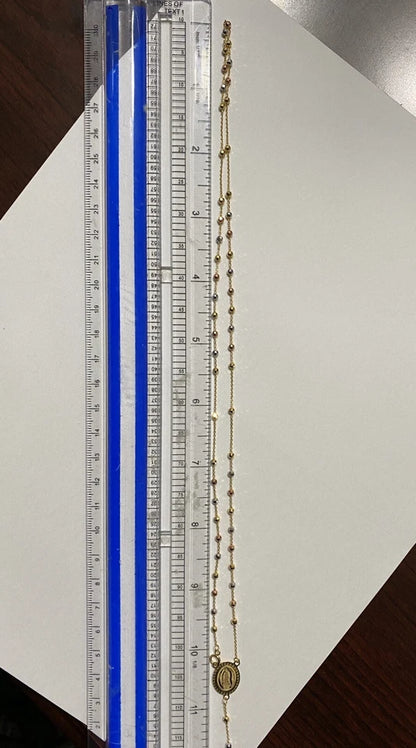 Gold necklace with a ruler for scale on a white background availabe on TX.ORO website.