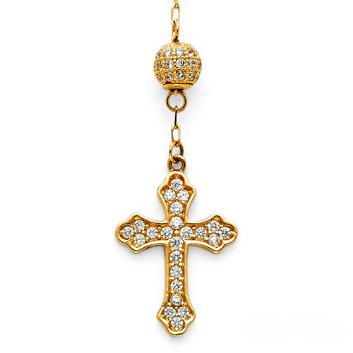 Gold cross pendant with clear stones on a white background available on the TX.ORO website.