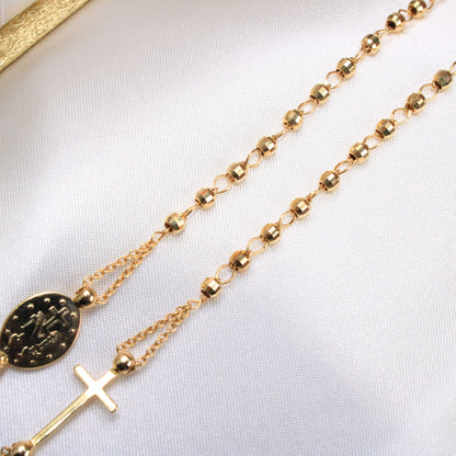 Gold rosary necklace on a white background available on the TX.ORO website.